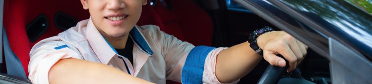 Portrait young handsome man sitting and smiling with happiness in a car